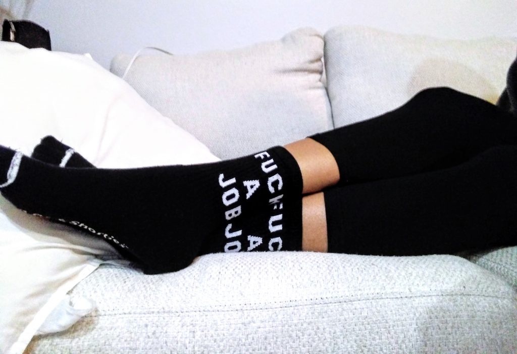 black fuck a job socks, lounging on sofa